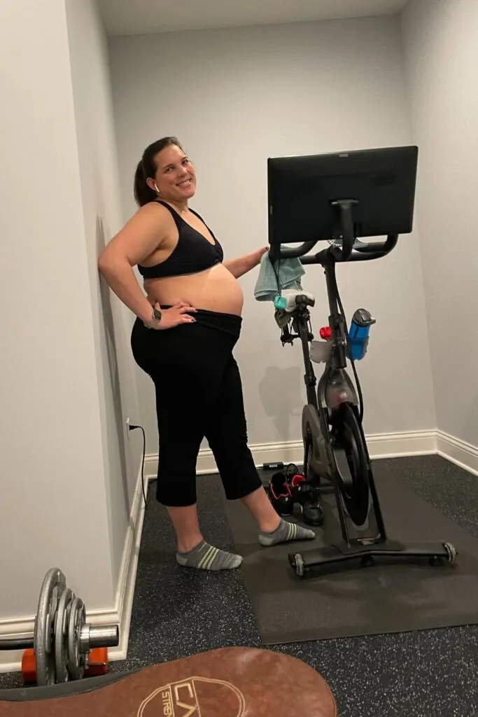 plus size pregnant woman exercising with a bike