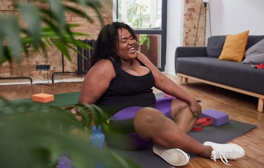 plus size pregnant woman doing yoga