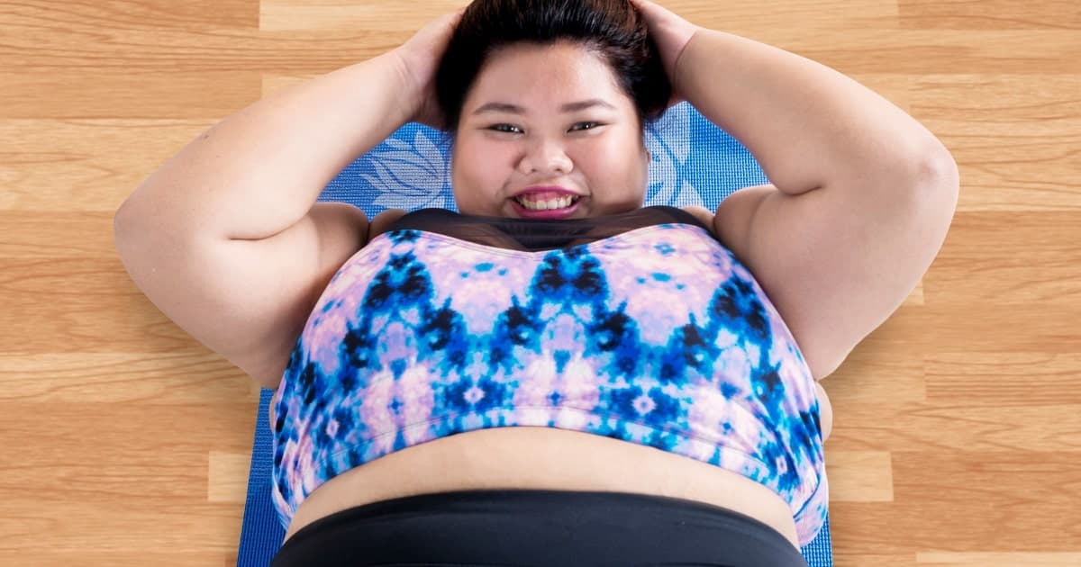 plus size woman doing prenatal yoga