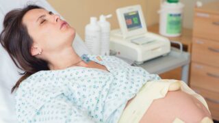 woman having an orgasm while giving birth