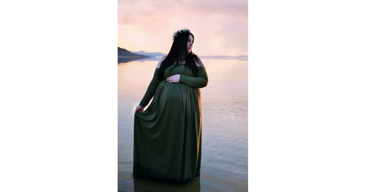 plus size pregnant woman standing in a lake