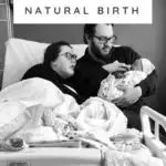 plus size couple in bed with newborn baby