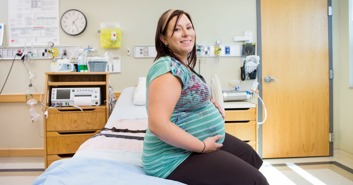 plus size pregnant woman sitting on a hospital bed