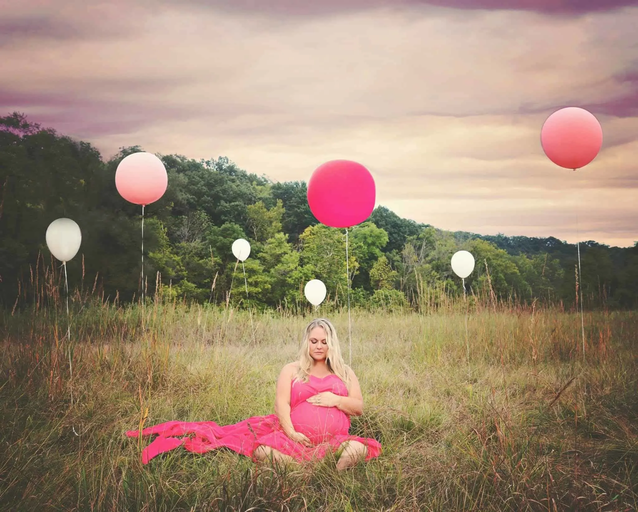 plus size maternity photo pink dress in field with balloons 