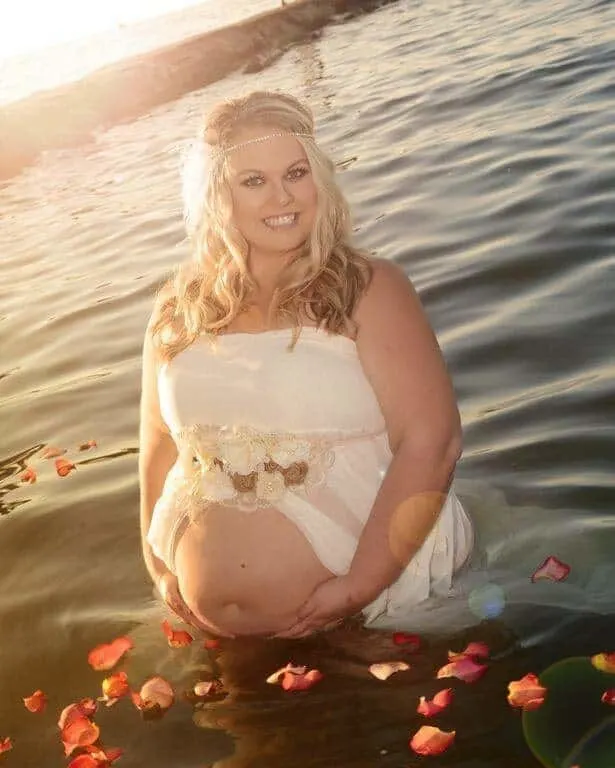 plus size pregnant woman standing in lake