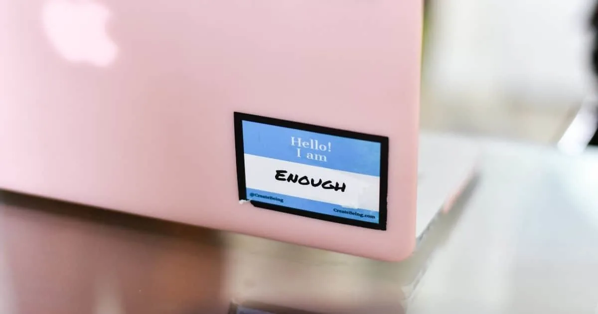 pink computer with sticker