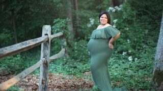 plus size woman in green dress for maternity photos with you are plus size