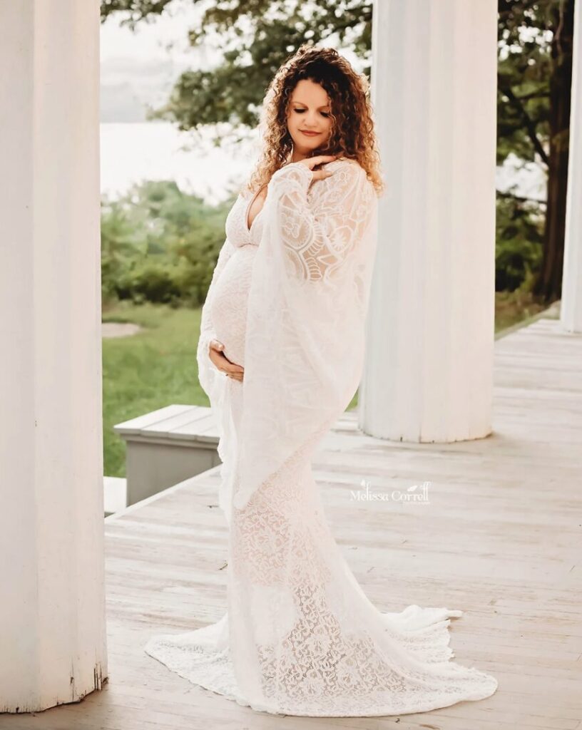 Woman wearing a plus size bohemian lace maternity wedding gown 