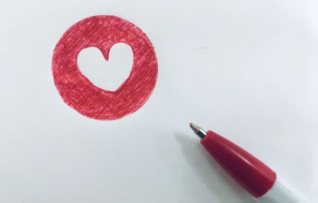 red pen and heart for processing emotions