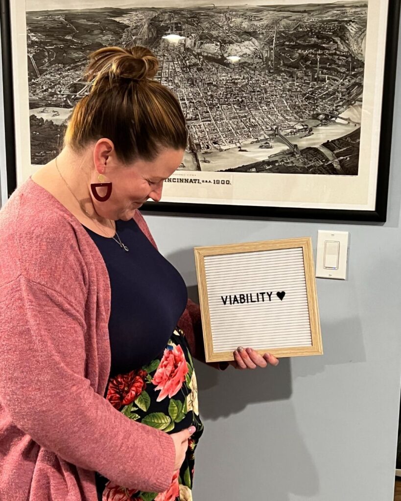 maternity photo with letter board that says viability
