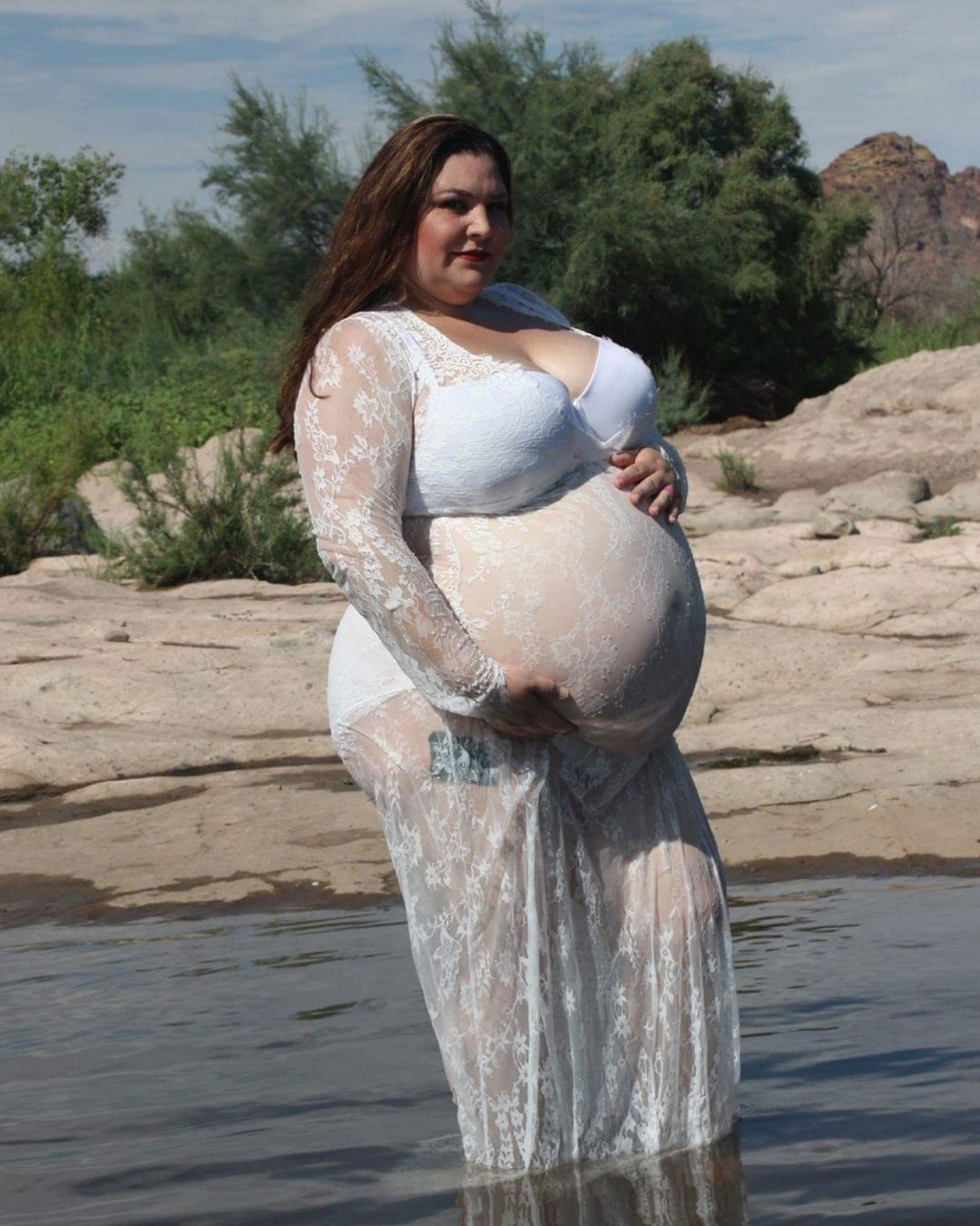 side plus size maternity boudoir pose in white lace